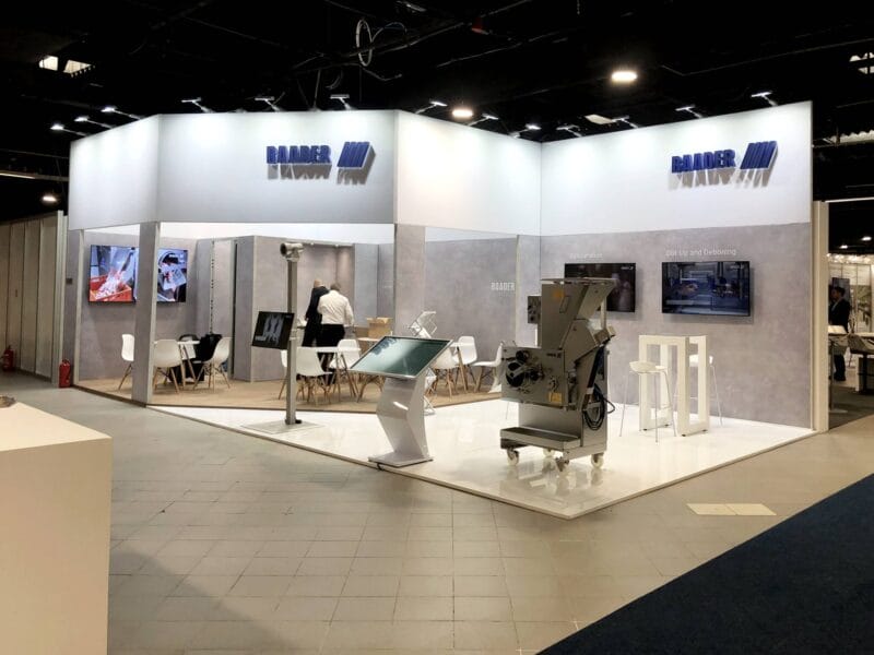 Fully equipped trade show booth for Baader – lighting, furniture, and modular details.