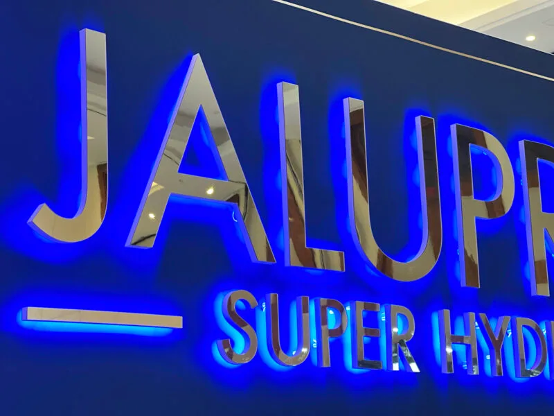 Illuminated 3D LED logo at an aesthetic medicine expo