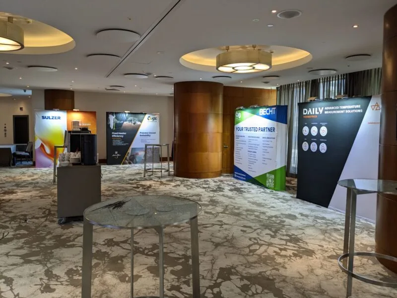 Compact hotel booth with counter and graphic wall, ideal for conferences