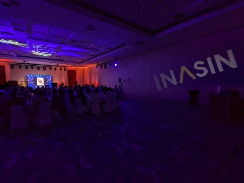 Event logo projected onto a wall with LED lighting